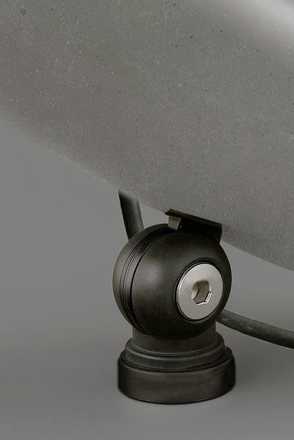 Close-up of a ball joint base with a gray shade on a neutral background