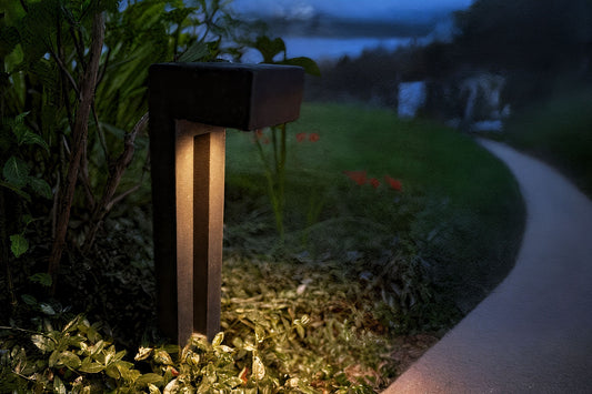 Garden light fixture illuminating a pathway at night