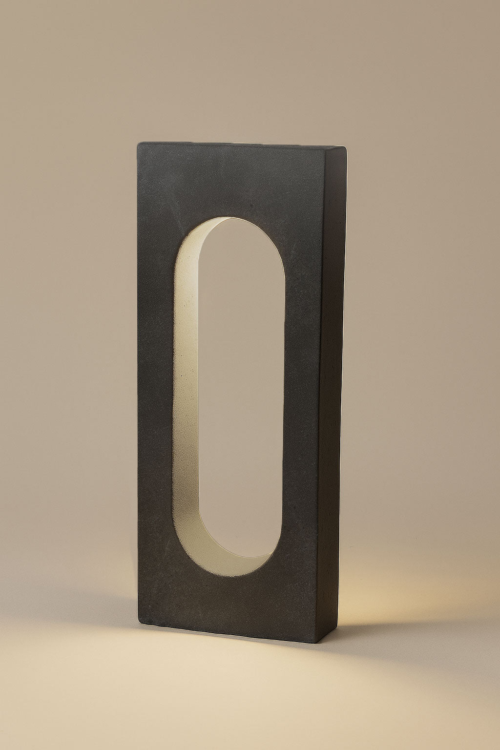 Rectangular light fixture with a central oval cutout on a beige background