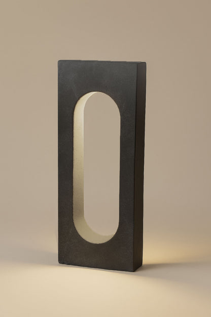 Rectangular light fixture with a central oval cutout on a beige background